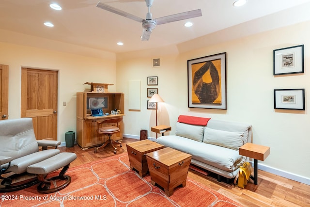 living room with hardwood / wood-style floors and ceiling fan