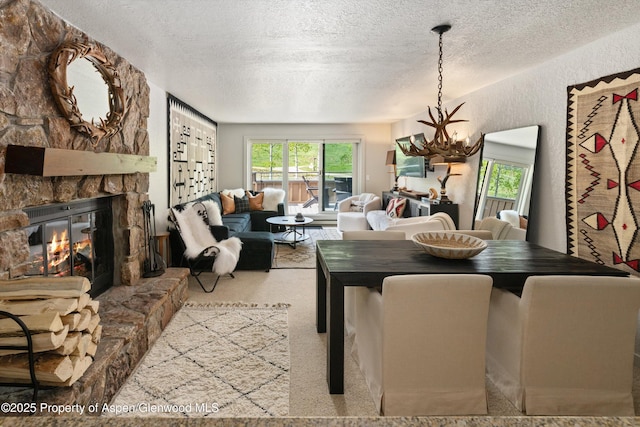 294 Snowmass Club Cir Unit 1207, Snowmass Village, CO 81615 - carpeted dining area featuring a textured ceiling and a stone fireplace