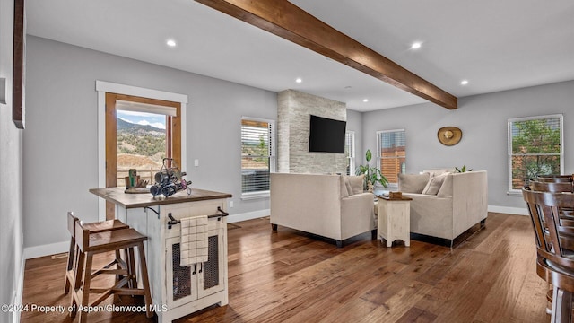 living room with dark wood finished floors, beamed ceiling, recessed lighting, and baseboards