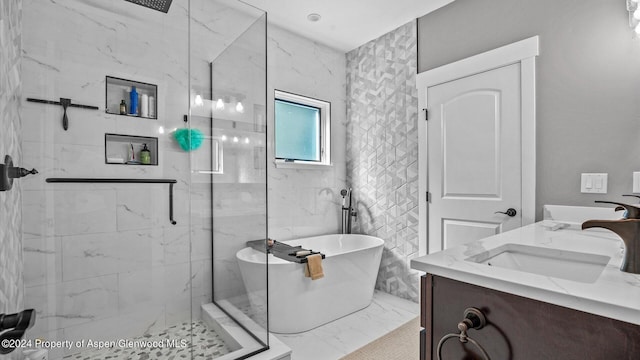 bathroom with a sink, a marble finish shower, a soaking tub, and marble finish floor