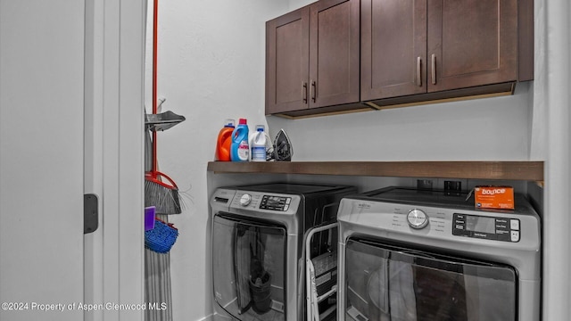 clothes washing area with cabinet space and washer and clothes dryer