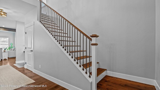 stairs with baseboards and wood finished floors