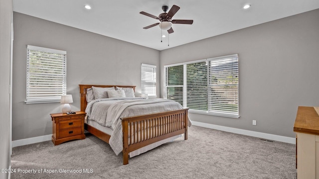 carpeted bedroom featuring recessed lighting, visible vents, and baseboards