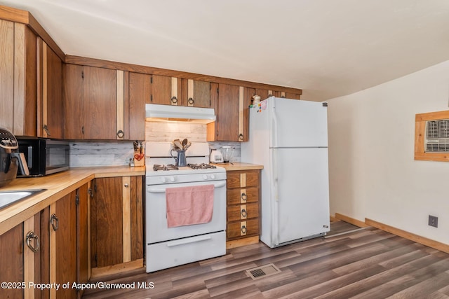 1618 Barclay St, Craig, CO 81625 - kitchen with white appliances, under cabinet range hood, light countertops, and decorative backsplash