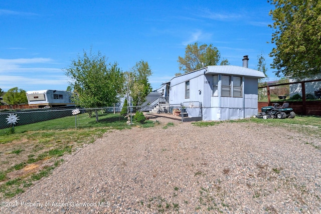 1618 Barclay St, Craig, CO 81625 - view of property exterior with a chimney, a fenced backyard, and driveway