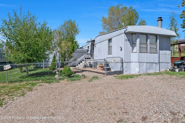 1618 Barclay St, Craig, CO 81625 - view of property exterior featuring a chimney and a gate