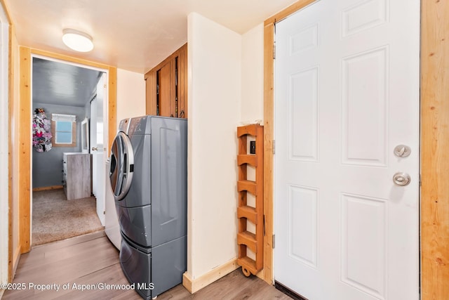 1618 Barclay St, Craig, CO 81625 - washroom with light wood-style floors, washer and dryer, cabinet space, and baseboards