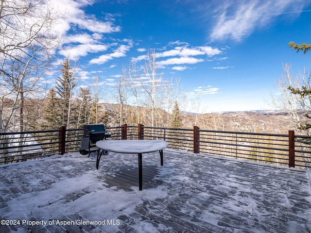 deck featuring a mountain view and a grill