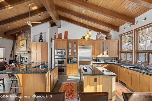 kitchen featuring a spacious island, sink, built in appliances, high vaulted ceiling, and beamed ceiling