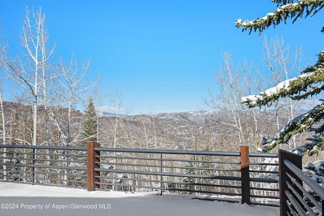 snow covered deck featuring a mountain view