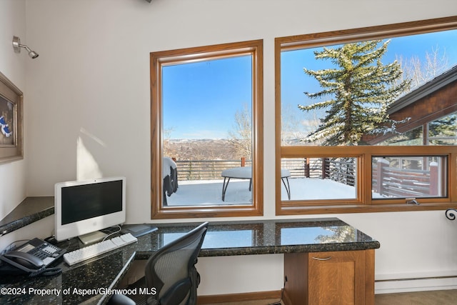 home office featuring built in desk and a baseboard heating unit