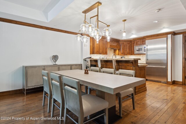 415 E Dean St B, Week 26, St, Aspen, CO 81611 - dining area featuring a tray ceiling, sink, and dark wood-type flooring
