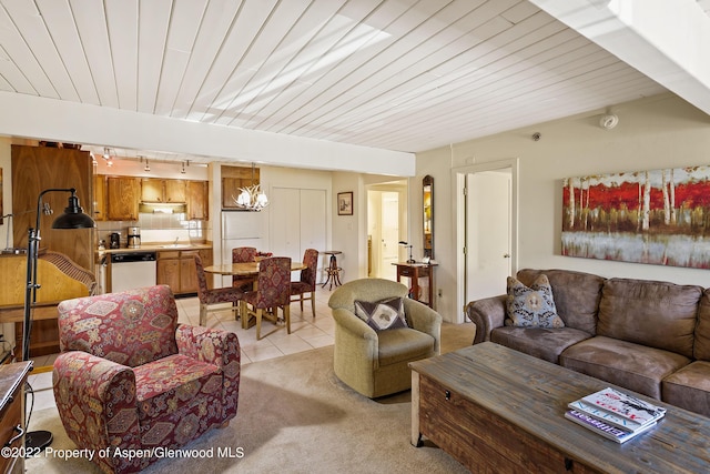 living area featuring rail lighting, light tile patterned flooring, light carpet, and wood ceiling