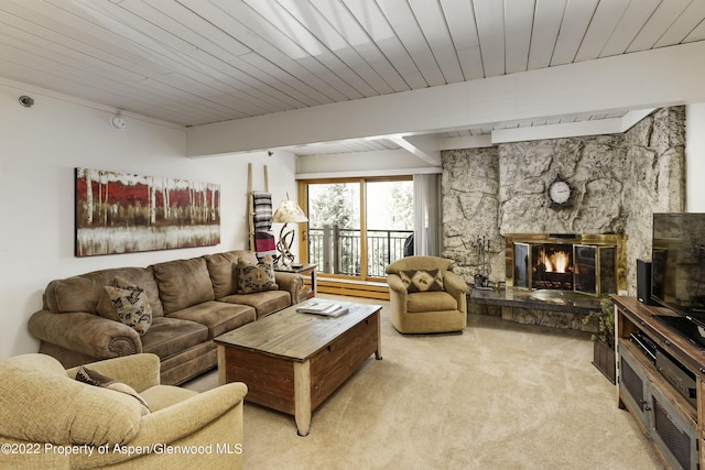 living room featuring light colored carpet, a stone fireplace, baseboard heating, wooden ceiling, and beamed ceiling