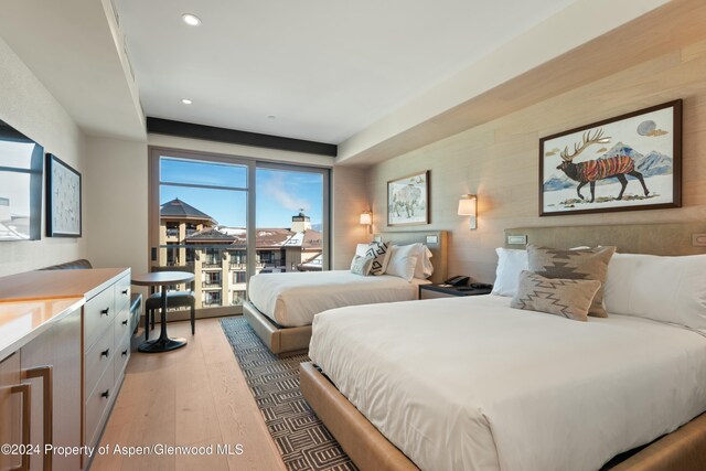 bedroom featuring hardwood / wood-style flooring and access to outside