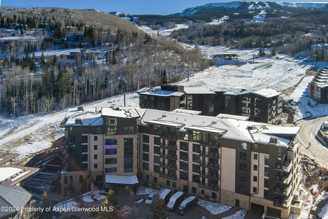 snowy aerial view with a mountain view