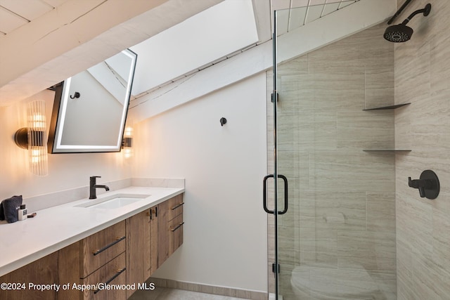 bathroom with vanity and a shower with door