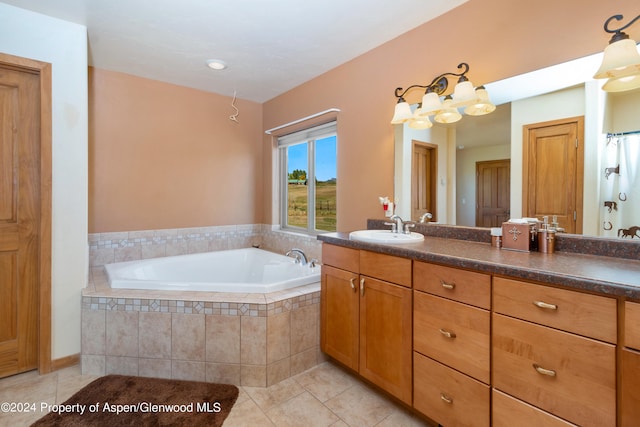 bathroom featuring tile patterned floors, vanity, and a relaxing tiled tub