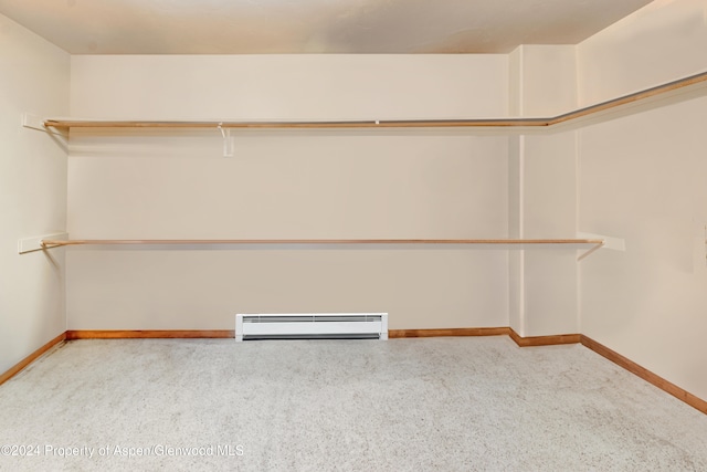 walk in closet featuring carpet flooring and baseboard heating