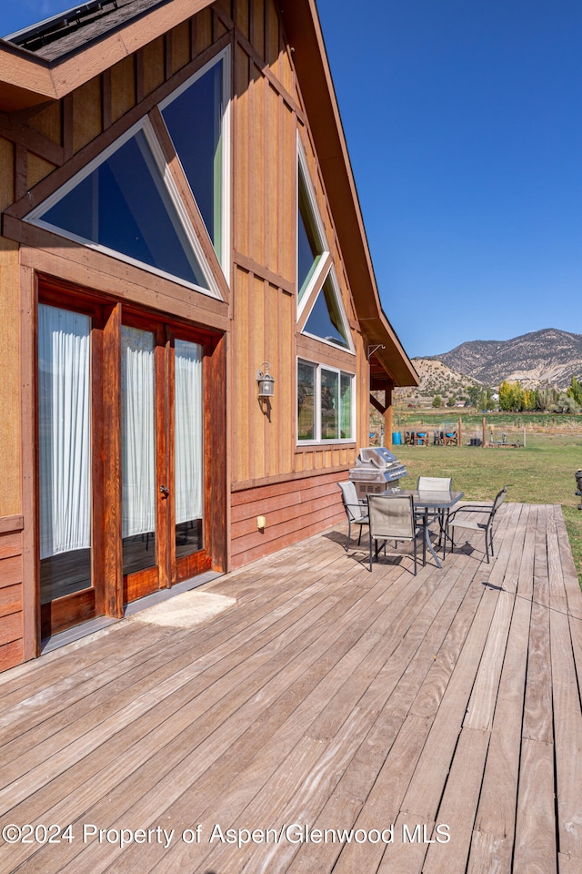 wooden deck with a mountain view