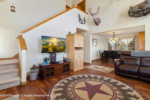 living room with high vaulted ceiling, a chandelier, and hardwood / wood-style flooring