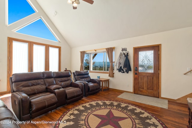 living room with dark hardwood / wood-style floors, high vaulted ceiling, and ceiling fan