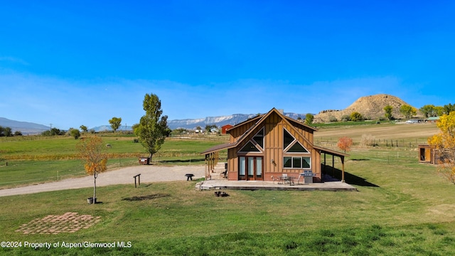 view of play area with a mountain view, a yard, and a rural view