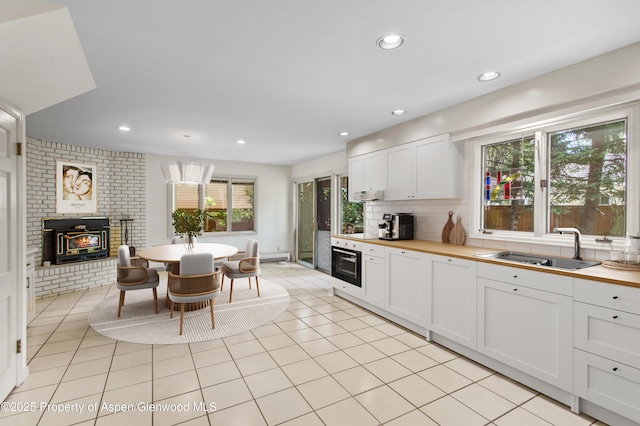 531 Gillespie St, Aspen, CO 81611 - kitchen featuring oven, a sink, butcher block countertops, recessed lighting, and decorative backsplash