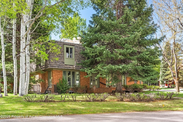 531 Gillespie St, Aspen, CO 81611 - front of property with mansard roof, brick siding, and a front lawn