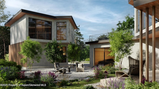 back of property with a patio area and stucco siding