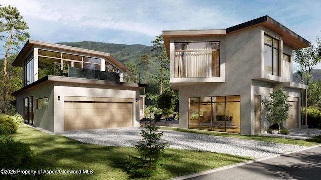 contemporary home featuring a mountain view, gravel driveway, a balcony, and stucco siding