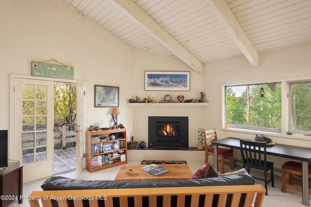 carpeted living room with lofted ceiling with beams, a healthy amount of sunlight, and wood ceiling