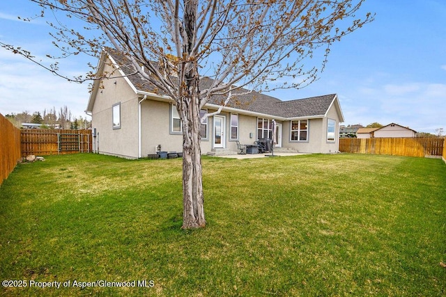 rear view of property with a patio area, stucco siding, and a shingled roof