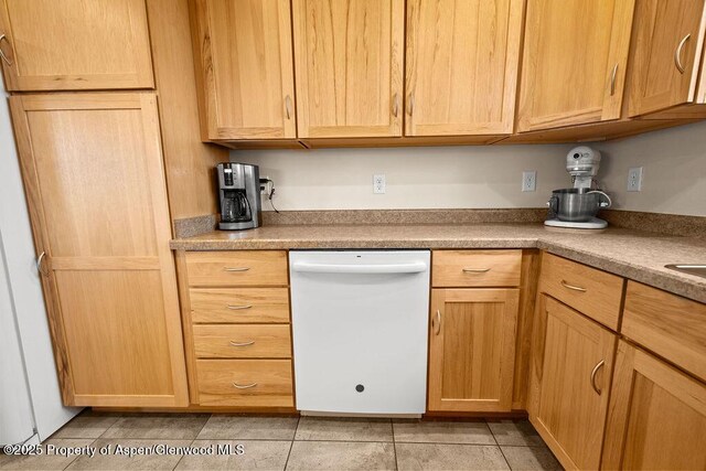 kitchen with dishwasher, light tile patterned flooring, and light brown cabinets