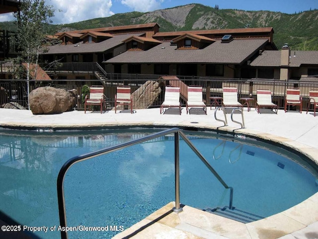 400 Wood Rd Unit 2104B, Snowmass Village, CO 81615 - community pool featuring a mountain view and a patio area