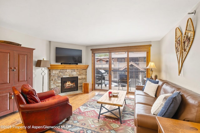 400 Wood Rd Unit 2104B, Snowmass Village, CO 81615 - living area with light wood-type flooring and a stone fireplace