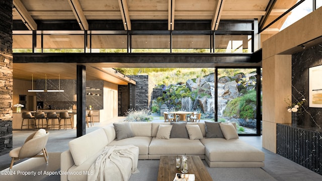 living room with beamed ceiling, wood ceiling, and a high ceiling