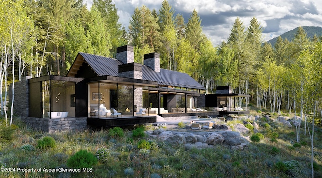 rear view of house featuring a mountain view