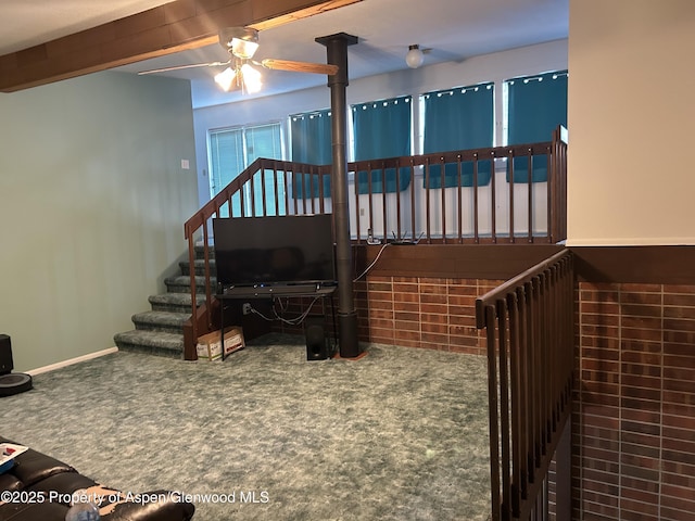 carpeted living room with baseboards and ceiling fan