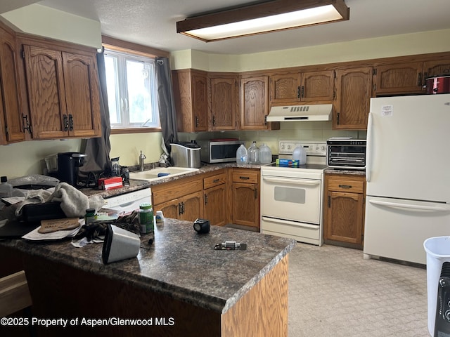 kitchen featuring white appliances, a toaster, a sink, under cabinet range hood, and brown cabinets