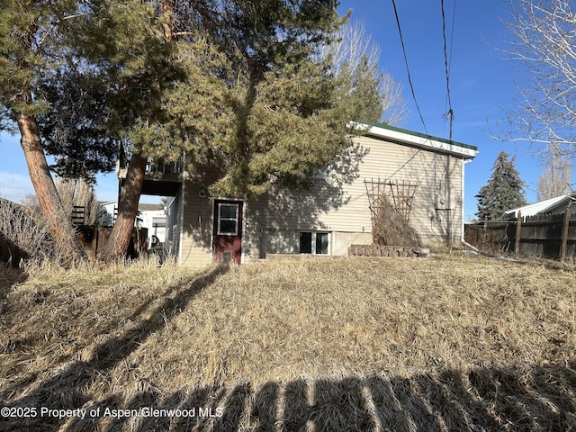 back of property featuring fence