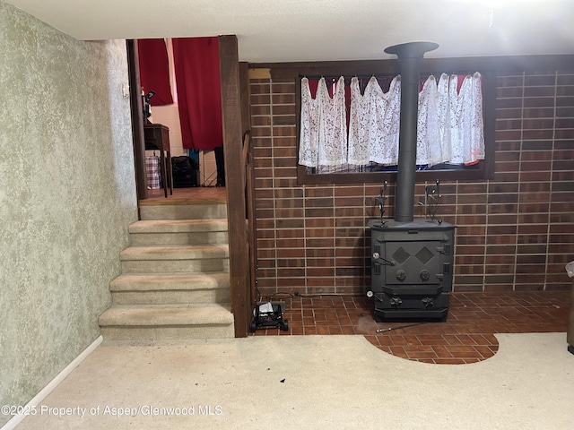 stairs with carpet floors and a wood stove