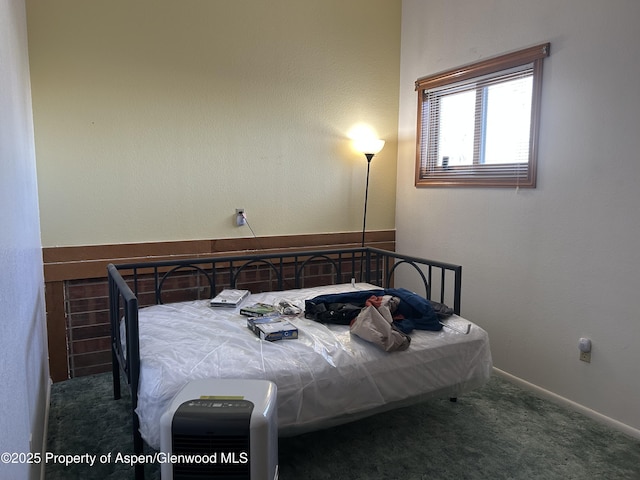 bedroom with baseboards and carpet floors