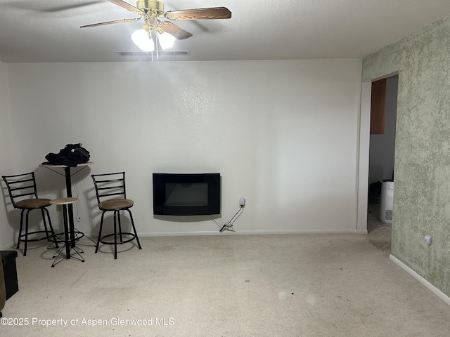 interior space with visible vents, baseboards, and a ceiling fan