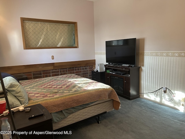 bedroom featuring carpet flooring and wainscoting