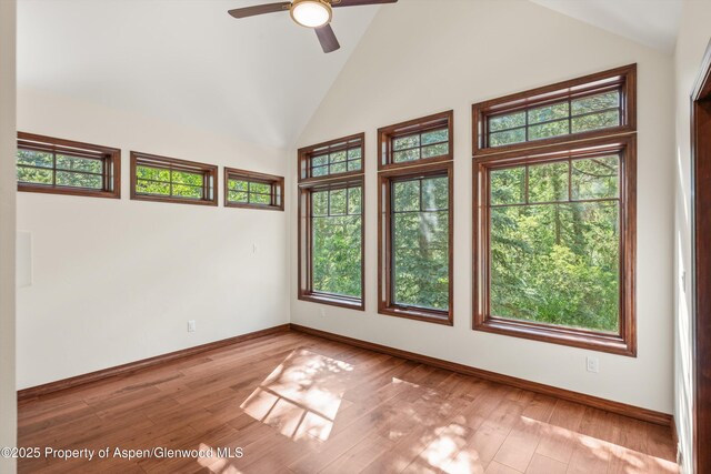 135 Irwin Dr, Redstone, CO 81623 - spare room featuring healthy amount of natural light, high vaulted ceiling, ceiling fan, and hardwood / wood-style flooring