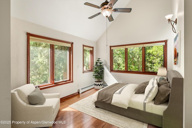 135 Irwin Dr, Redstone, CO 81623 - bedroom featuring high vaulted ceiling, wood finished floors, a baseboard heating unit, and ceiling fan