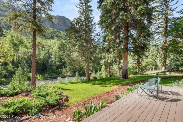 135 Irwin Dr, Redstone, CO 81623 - wooden deck featuring a mountain view, a lawn, and a forest view