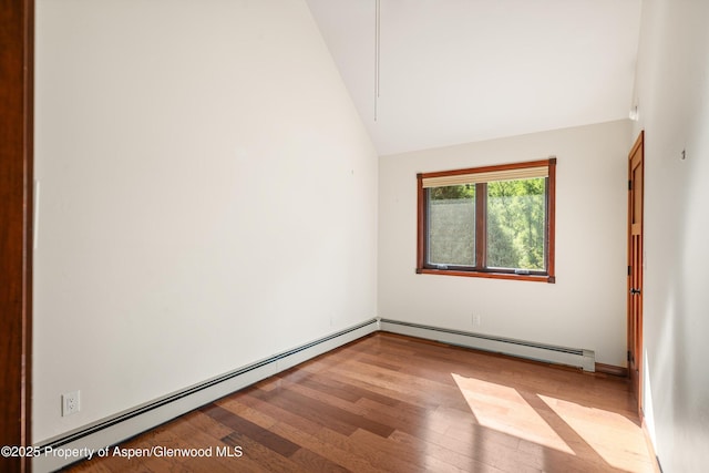 135 Irwin Dr, Redstone, CO 81623 - empty room featuring wood finished floors, vaulted ceiling, and a baseboard heating unit