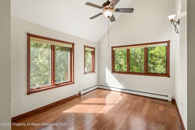 135 Irwin Dr, Redstone, CO 81623 - unfurnished room with baseboard heating, wood finished floors, a ceiling fan, and high vaulted ceiling